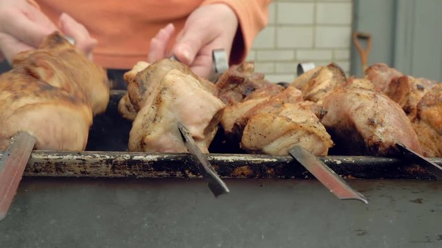 Barbeque skewers with meat cooking on hot coal ember brazier Outdoors picnic concept. 4K UHD video footage.