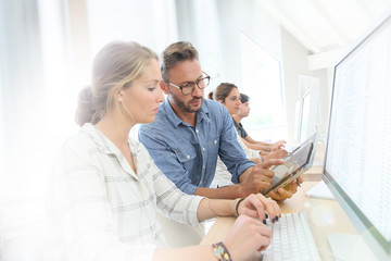 Obraz premium Student girl with teacher working on desktop computer