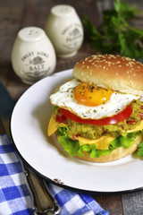 Vegetarian burger with guacamole and roasted egg.