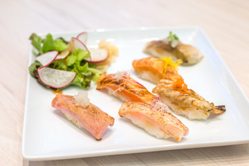 Mix sushi grilled on white plate; japanese food.
