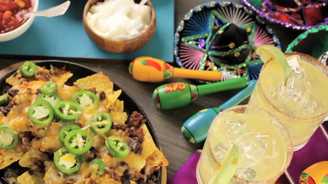 Classic nachos with ground beef and fresh jalapeno chili peppers