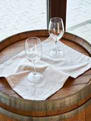 Empty wine glasses on wooden barrel