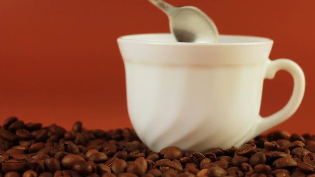 Man spoon prevents coffee on a brown background