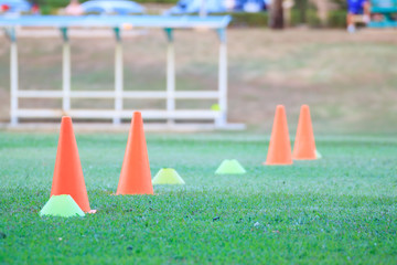 Plastic cone for training soccer ball on a green field