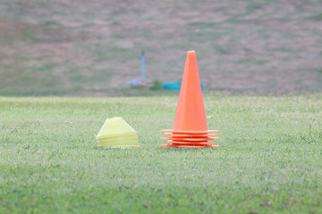 Plastic cone for football training on green grass