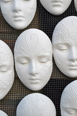 Handicraft masks which are casted from plaster to be raw models for coloring.
