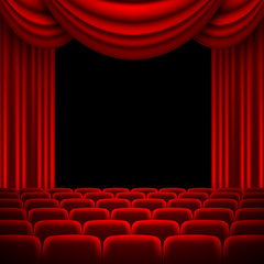 an auditorium with a red curtain