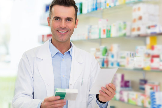 Pharmacist filling prescription in pharmacy
