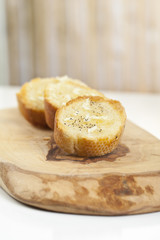 slices of toasted baguette with butter, garlic and herbs