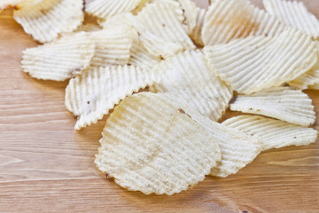 potato chips on wooden board