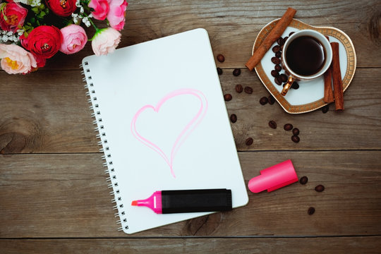 notepad with a painted heart, coffee and flowers