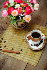 cup black coffee, cinnamon and flowers