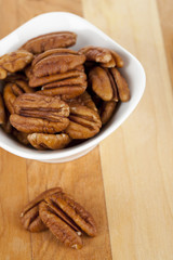 white bowl full of pecan nuts