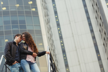 Young couple hugging while sitting on staircase