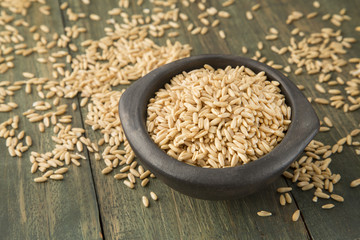 Oat grains on wooden background