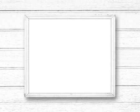 White blank old picture frame on white wood wall.