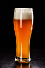 Beer Glass on black. Bar drink. Beer bubbles closeup. DRAFT LIGHT. Overflow beer glass. Beer beverage. Glass of alcohol. Closeup draft beer glass. Cold Beer. Pint of beer. Good for brewery commercial