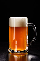 Beer Glass on black. Bar drink. Beer bubbles closeup. DRAFT LIGHT. Overflow beer glass. Beer beverage. Glass of alcohol. Closeup draft beer glass. Cold Beer. Pint of beer. Good for brewery commercial