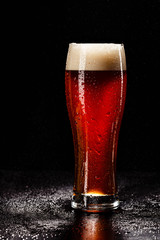 Beer Glass with DROPS on black. FRESH! MUCH FOAM! Beer bubbles closeup. DRAFT. Overflow beer glass. Beer beverage. Glass of alcohol. Closeup Cold Beer. Pint of beer. Good for brewery commercial