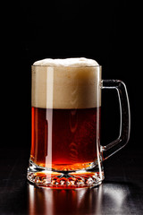 Beer Glass with DROPS on black. FRESH! MUCH FOAM! Beer bubbles c