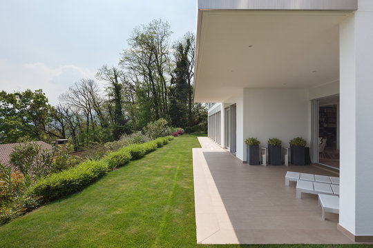House, veranda with green lawn