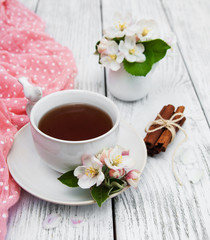 Fototapeta na wymiar cup of tea with apple blossoms