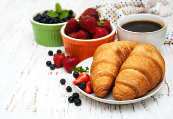 Fresh berries, coffee and croissant