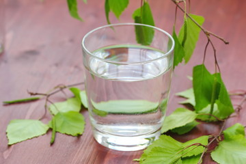Glass of clean water on natural background