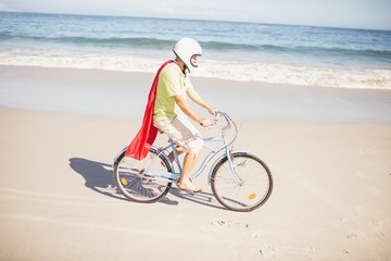Fototapeta premium Senior superhero riding bike