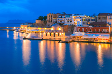 Picturesque panoramic view of Venetian quay of Chania with Kucuk Hasan Pasha Mosque during twilight blue hour, Crete, Greece