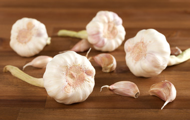 garlic bulb and clove on wooden background