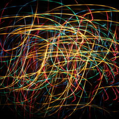 Christmas and New Year extravaganza lights/abstract background with colored lights wandering ribbons in the dark