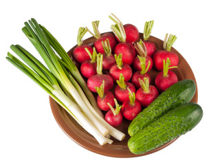 Plate with vegetables on white background