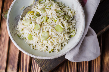 Rice pilaf with fava beans on wooden background. Selective focus