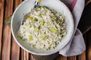 Rice pilaf with fava beans on wooden background. Selective focus
