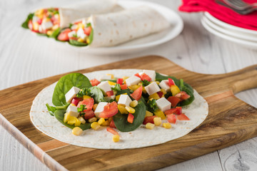 vegan tofu wraps with pepper, corn, tomatoes and spinach