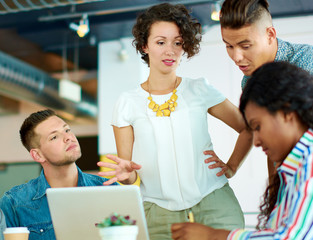 Candid image of a group with succesful business people caught in an animated brainstorming meeting