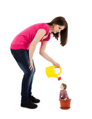 mother watering baby plant