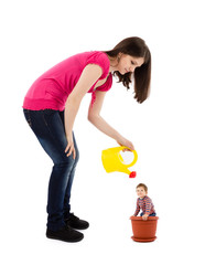 mother watering baby plant