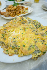 A large flat Chinese omelette on a plate 