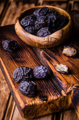 Fresh Dates on vintage wooden background. Selective focus. Toned image