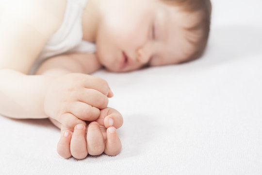 Newborn baby sweet sleeping on a white bed
