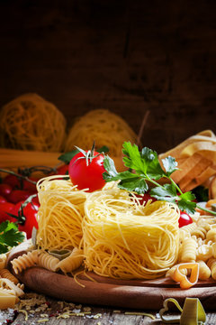 Nests Italian dry pasta, aasorti different kinds of pasta, parsl