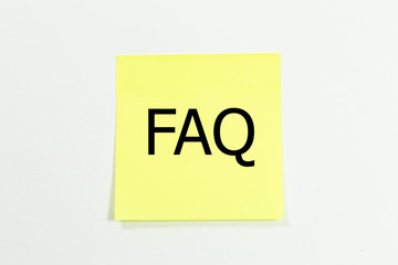 The acronym FAQ - Frequently Asked Questions on yellow sticky notes. isolated on white 