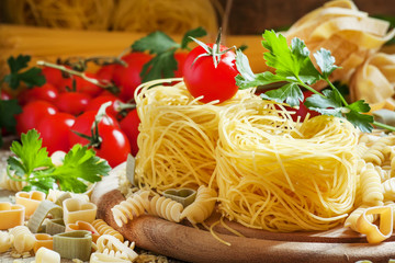 Nests Italian dry pasta, aasorti different kinds of pasta, parsl