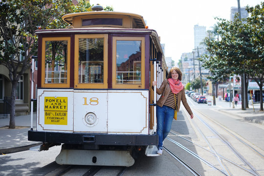 Tourist taking a ride in cable car in San Francisco, California, USA