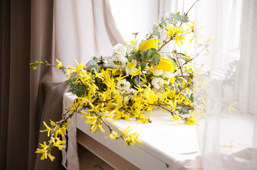 Beautiful bouquet of yellow flowers in the window