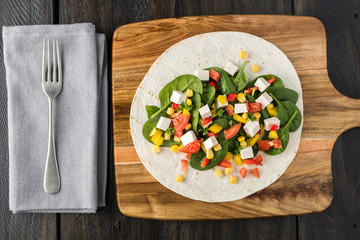 vegan tofu wraps with pepper, corn, tomatoes and spinach