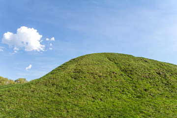 covered with green grass hill and blue sky with cloud