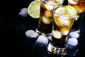 Alcoholic cocktail spiced rum with cola, lime and ice cubes, sha